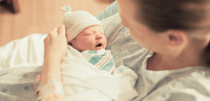 Newborn Care Specialist supporting infant in Los Angeles